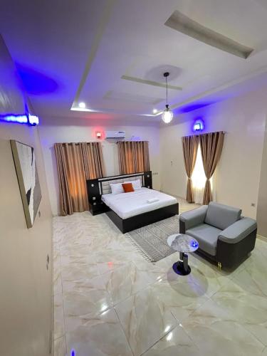 a bedroom with a bed and a couch in a room at Goshen in Iju Junction