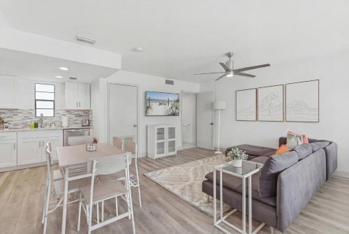 a living room with a couch and a table at Be A Nomad - 2BR Jacksonville Beach Apartment - 1 Min to Beach - Sleeps 4 in Jacksonville Beach
