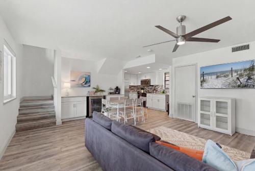 a living room with a couch and a ceiling fan at Be A Nomad - 2BR Jacksonville Beach Apartment - 1 Min to Beach - Sleeps 4 in Jacksonville Beach