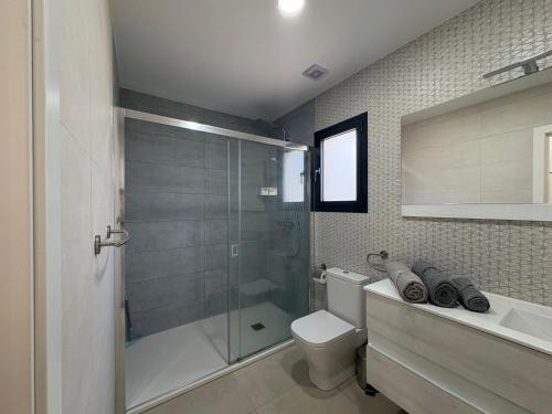 a bathroom with a shower and a toilet and a sink at Vivienda en Granada, Cortijo Balcón Cotobro, Almuñécar, Casa con piscina y vistas increíbles in Granada