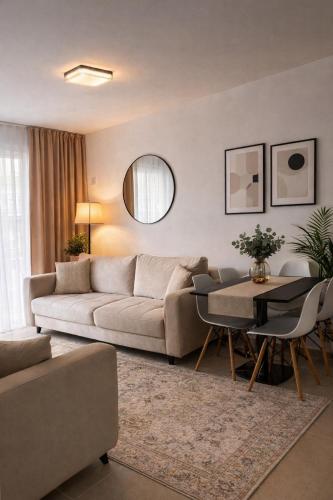 a living room with a couch and a table at Holiday apartaments Gaca in Lezhë