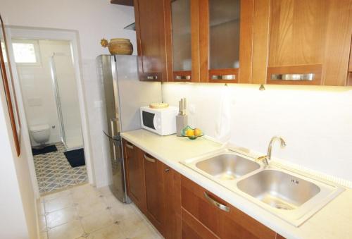 a kitchen with a sink and a microwave at House PUNTA II in Umag