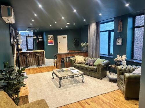 a living room with two couches and a table at STUNNING Loft Apartments in Jarrow, South Tyneside in East Howdon