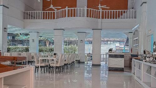 a dining room with tables and chairs in a building at Pooh Beach Resort & Spa in Jomtien Beach