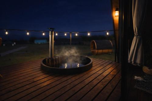 a fire pit on a deck at night at Cabaña Con Impresionante Vista Volcan y Lago AYUN LAFQUEN in Villarrica