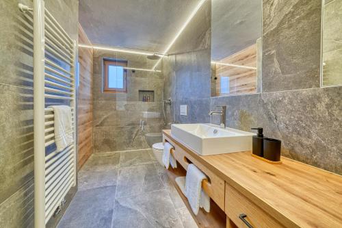 a bathroom with a white sink and a shower at Gattererhof in Schenna