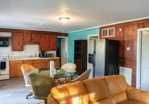 a living room with a table and a refrigerator at GpL 2668 tree bedrooms and 2 bathrooms in Fort Myers