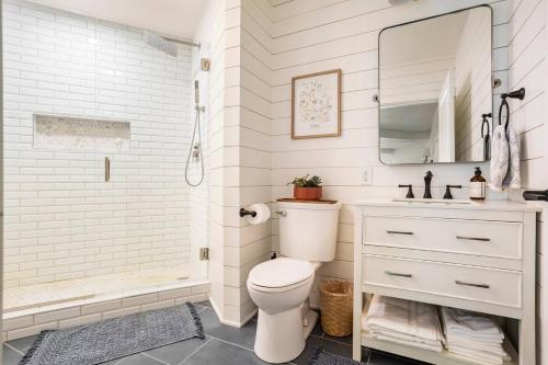 a white bathroom with a toilet and a sink at Cozy Country Guest Suite in Zionsville