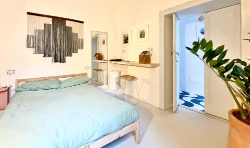 a bedroom with a bed and a potted plant at OSA - Stella - Garden Hostel with bar in Naples