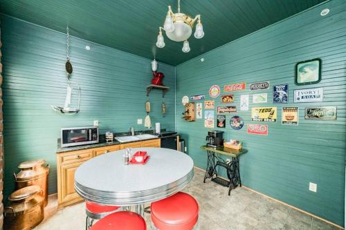 a kitchen with a table and red chairs in a room at The Long Run - 2 CA King Sized Beds+ - Sleeps 8-10 in Lynchburg