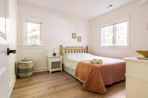 a bedroom with a bed and two windows at Cozy Country Guest Suite in Zionsville