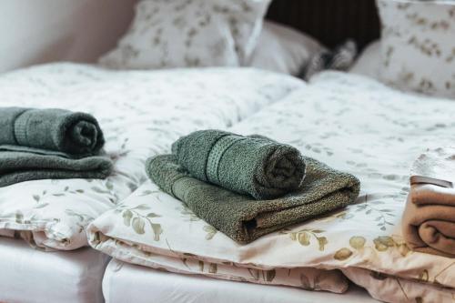 a bed with towels and pillows on it at Villa Nirvána in Františkovy Lázně