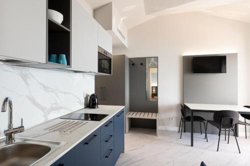 a kitchen with a sink and a table at Del Prado in Riva Ligure