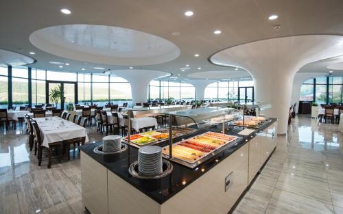 a restaurant with a buffet with tables and chairs at Grand Hotel Neum Wellness & Spa in Neum