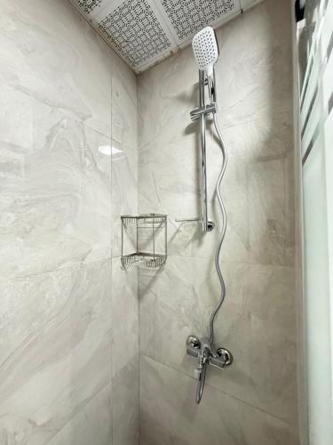 a shower with a shower head in a bathroom at Marina Hostel Pansiyon in Antalya
