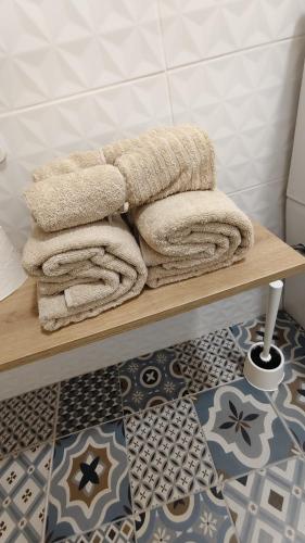 a pile of towels on a wooden shelf in a bathroom at HDEZfalcon in Las Lagunas
