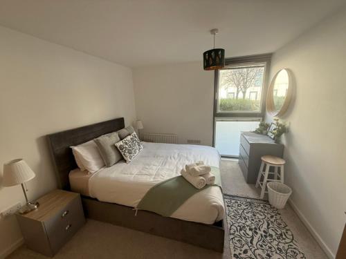 a bedroom with a large bed and a window at Thistle & Tide in Edinburgh