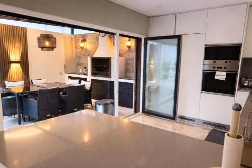 a kitchen with a large stainless steel table in a room at Modern Villa near Lisbon & Beaches with Heated Pool in Fernao Ferro