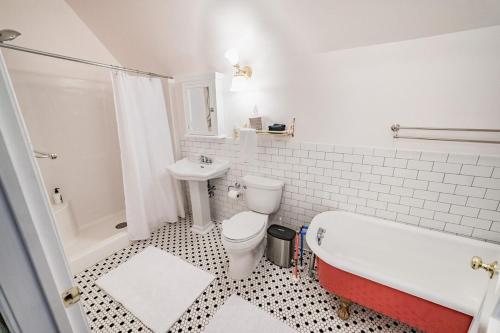 a bathroom with a tub and a toilet and a sink at Desperado - CA King Size Bed - Sleeps 2-4 in Lynchburg