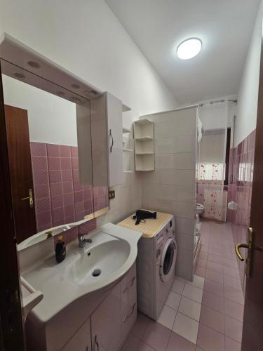 a bathroom with a sink and a washing machine at Daniela House in Maiori