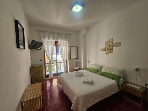 a bedroom with a large bed and a window at Daniela House in Maiori