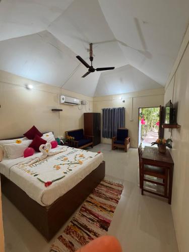 a bedroom with a bed and a ceiling fan at Havelock Farms Resort in Havelock Island