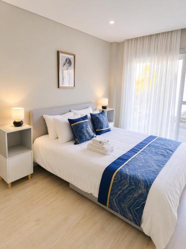 a bedroom with a large bed and a window at Modern Villa near Lisbon & Beaches with Heated Pool in Fernao Ferro