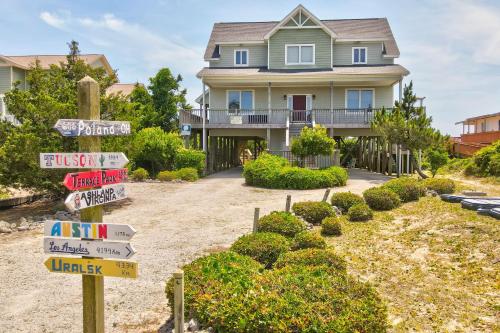 a house with a bunch of street signs in front of it at Azohva by Oak Island Accommodations in Caswell Beach