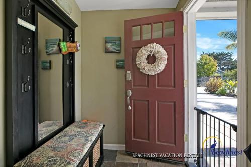 a red door with a wreath on it at Beach Lovers Retreat in Santa Cruz