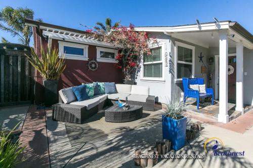 a patio with a couch and a table and chairs at Beach Lovers Retreat in Santa Cruz