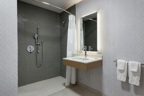 a bathroom with a sink and a shower at SpringHill Suites by Marriott Lancaster Palmdale in Lancaster