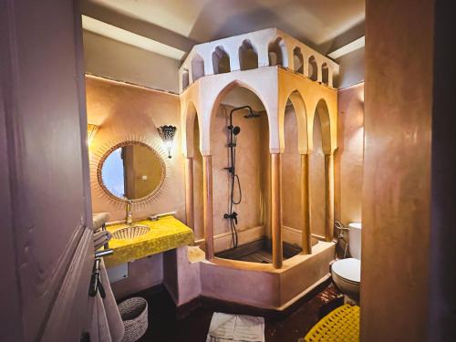 a bathroom with a shower and a sink and a toilet at Riad Maison Palmier in Marrakesh