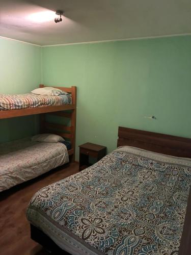 a room with two beds in a room with at Cabañas rio fuy Tinaja in Puyehue