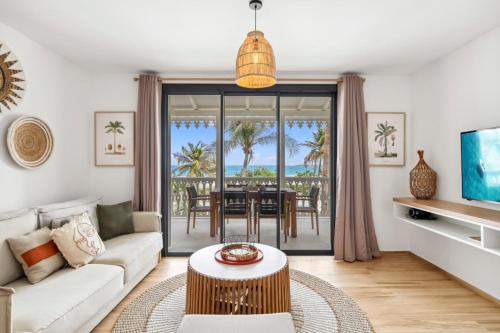 a living room with a couch and a table at Alamanda 114 Oceanview 2BR Steps from Orient Bay in Orient Bay