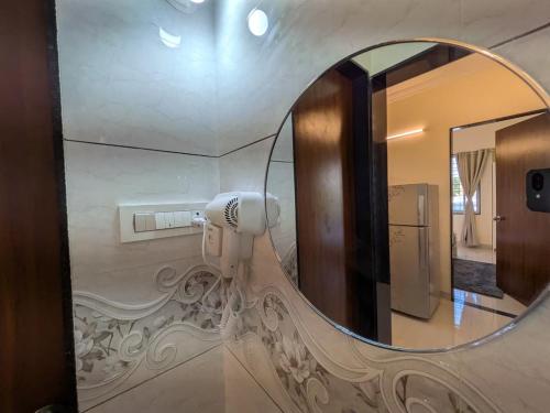 a mirror in a bathroom with a hair dryer at Nova Residences Viman Studios in Pune
