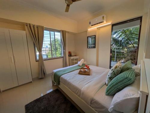 a bedroom with a large bed with a large window at Nova Residences Viman Studios in Pune