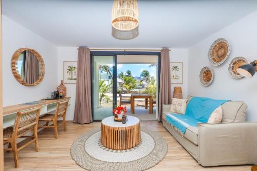a living room with a couch and a table at Studio 6 Alamanda Resort Orient Bay in Orient Bay