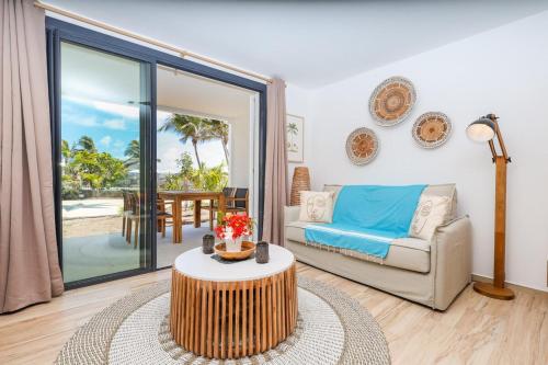 a living room with a couch and a table at Studio 6 Alamanda Resort Orient Bay in Orient Bay