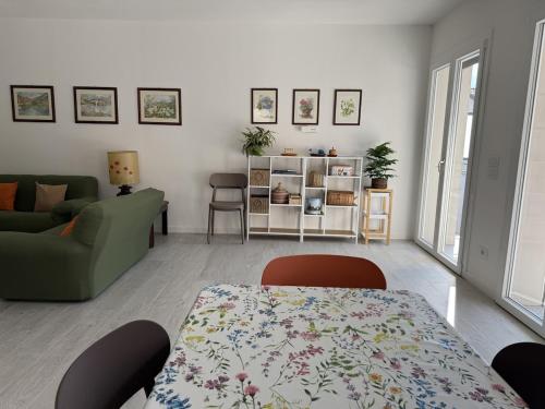 a living room with a table and a couch at A102 La Filanda by Larihome in Pianello Del Lario