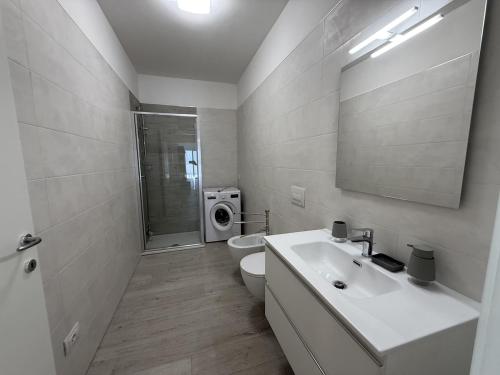 a bathroom with a sink and a toilet and a shower at A102 La Filanda by Larihome in Pianello Del Lario
