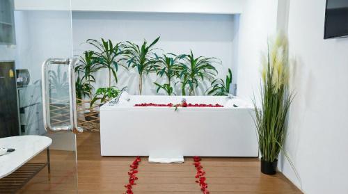 a white bath tub with plants in a room at Pooh Beach Resort & Spa in Jomtien Beach