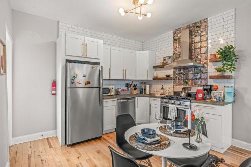 a kitchen with a stainless steel refrigerator and a table at Pet Friendly- Big- King Bed Minutes 2 Stadiums in Philadelphia