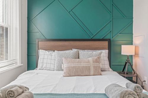 a bedroom with a bed with a blue wall at Pet Friendly- Big- King Bed Minutes 2 Stadiums in Philadelphia