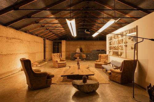 a living room with chairs and a table in a room at Fauna Atacama in San Pedro de Atacama