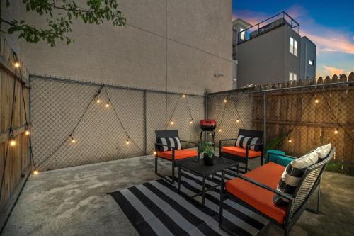 a patio with chairs and a table and lights at Spacious 3BR Near Art Museum Patio Gameroom in Philadelphia