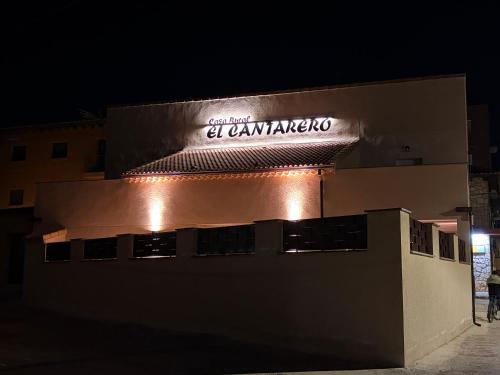 a sign on top of a building at night at Casa Rural El Cantarero in Ariza