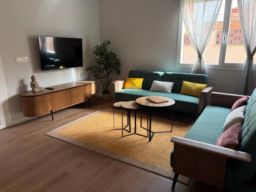 a living room with a couch and a tv at Casa Rural El Cantarero in Ariza