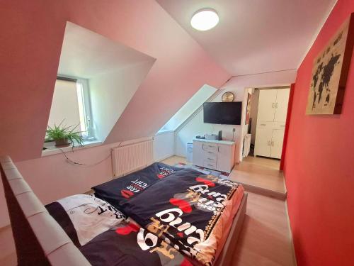 a bedroom with a bed in a attic at KissApartman in Kőszeg