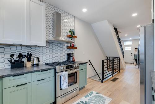a kitchen with blue cabinets and a stove at Easy Walk 2 Stadiums- Kid Friendly Game Room in Philadelphia