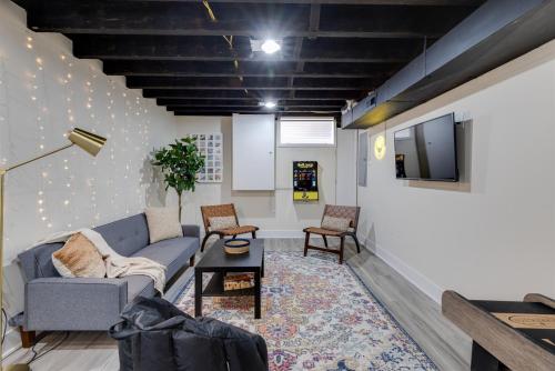 a living room with a couch and a tv at Easy Walk 2 Stadiums- Kid Friendly Game Room in Philadelphia